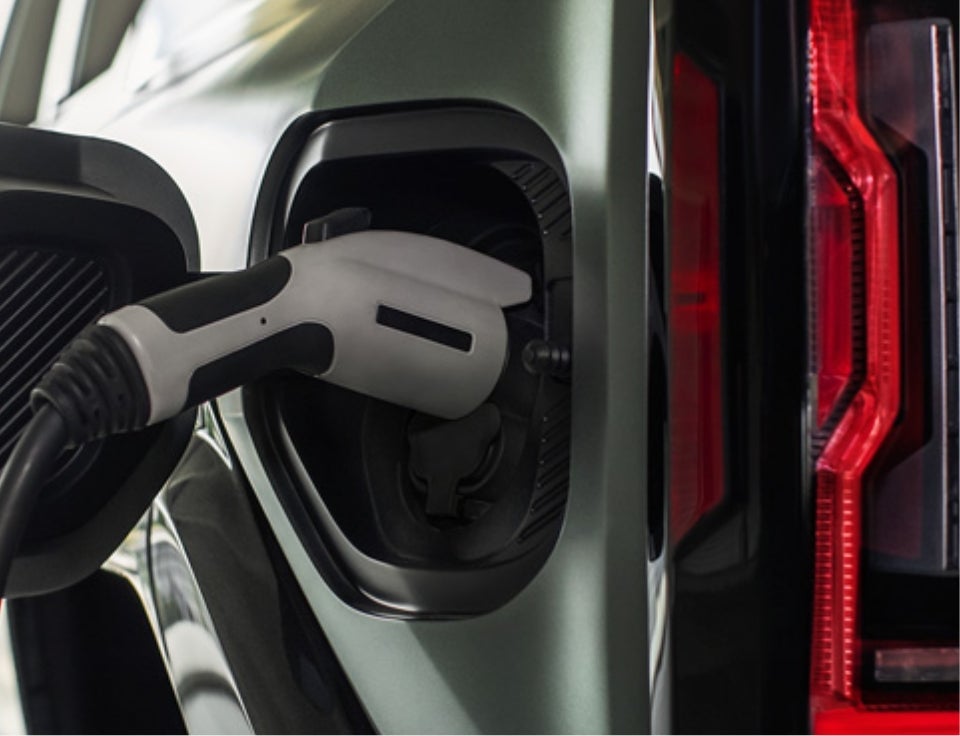 Close up of charging port with charger plugged in on a GMC Hummer EV SUV - Jim Cook GMC in Marion NC